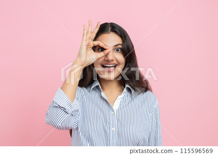 Happy positive Indian woman showing ok gesture 115596569