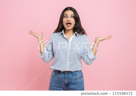 Shocked Indian woman spreading hands Shocked Indian woman spreading hands 115596572