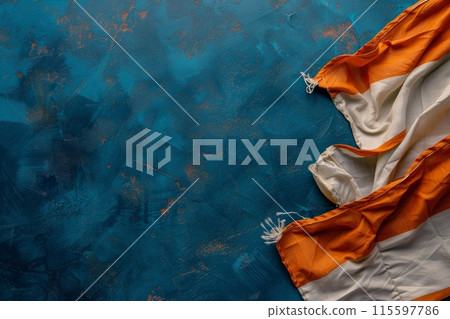 White and Orange Striped Fabric on Blue Background 115597786