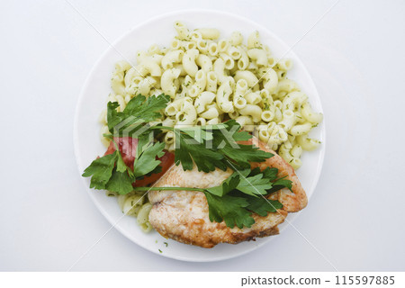 Fried chicken meat with a side dish of pasta. Delicious meat breakfast. 115597885