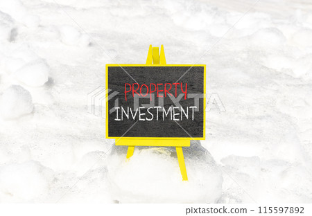 Property investment symbol. Concept words Property investment on beautiful yellow blackboard. Beautiful white snow background. Business Property investment concept. Copy space. 115597892