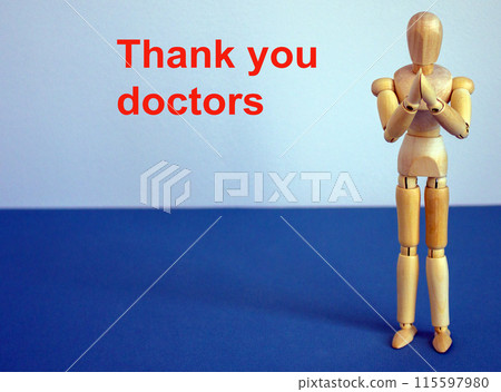 COVID-19 Pandemic Coronavirus concept. Wooden model of a man. Thank you doctors inscription. COVID-19 Pandemic Coronavirus concept. Wooden model of a man. Thank you doctors inscription. 115597980