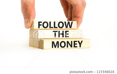 Follow the money symbol. Concept words Follow the money on beautiful wooden blocks. Beautiful white table white background. Businessman hand. Business and follow the money concept. Copy space. Follow the money symbol. Concept words Follow the money on beautiful wooden blocks. Beautiful white table white background. Businessman hand. Business and follow the money concept. Copy space. 115598028
