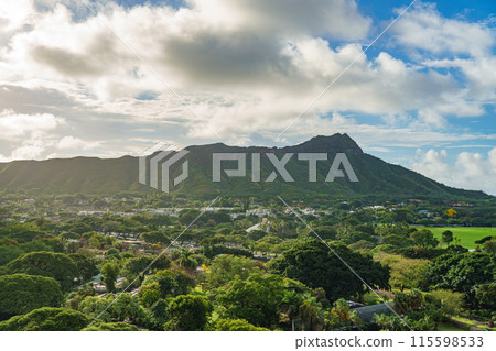 Aerial view of a mountain with trees, houses, greenery, under cloudy sky Aerial view of a mountain with trees, houses, greenery, under cloudy sky 115598533