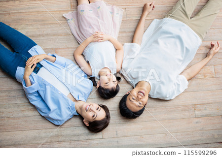 A friendly family lying on the floor 115599296