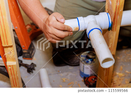 Using glue to join plastic PVC pipes, plumber uses 115599566
