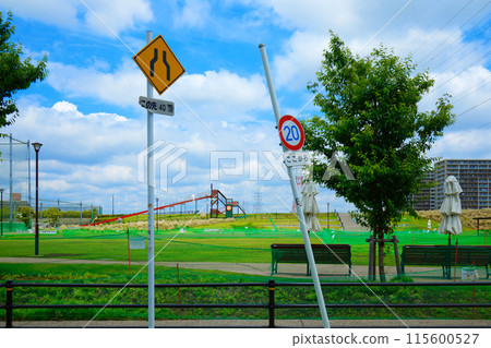 Road sign and long slide in front of the lawn square at Miyamae Park Road sign and long slide in front of the lawn square at Miyamae Park 115600527