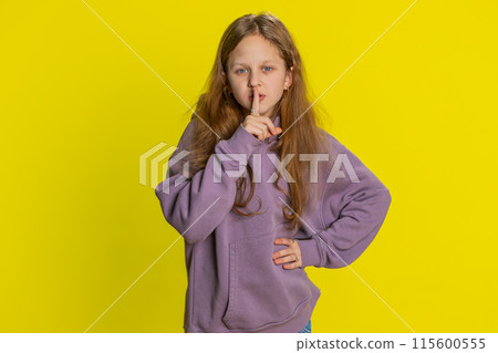 Preteen child girl presses finger to lips makes silence hush sign do not tells gossip secret, quiet Preteen child girl presses finger to lips makes silence hush sign do not tells gossip secret, quiet 115600555
