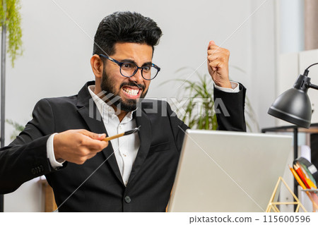 Angry businessman CEO making laptop call conversation at home office, quarrel conflict negotiation 115600596