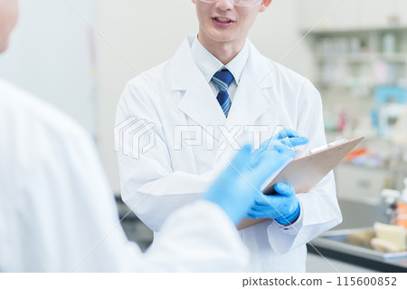 Scientists talking in the laboratory Scientists talking in the laboratory 115600852