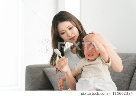 Young Asian mother/mom taking child's temperature (fever, fever, cold, crying) Young Asian mother/mom taking child's temperature (fever, fever, cold, crying) 115602384