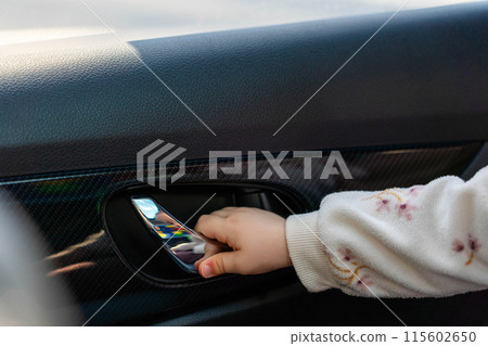 Child opens car door from inside. Concept of danger in car 115602650