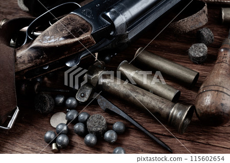 break-action smooth bored shotgun with brass cases and accessories for cartridge reloading. 115602654