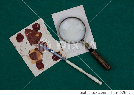 Retro envelope opener knife with magnifying glass and vintage letter envelope 115602662