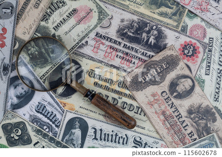 Retro US banknotes and silver certificates with silver dollar coins and magnifying glass Retro US banknotes and silver certificates with silver dollar coins and magnifying glass 115602678
