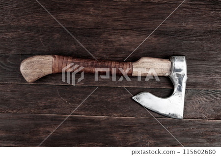 battle axe on wooden table 115602680