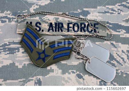 US AIR FORCE branch tape and Senior Airman rank patch and dog tags on digital tiger-stripe pattern Airman Battle Uniform background 115602697