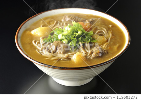 Hot curry soba noodles with plenty of green onions photographed against a black background Hot curry soba noodles with plenty of green onions photographed against a black background 115603272