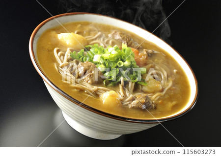 Hot curry soba noodles with plenty of green onions photographed against a black background Hot curry soba noodles with plenty of green onions photographed against a black background 115603273