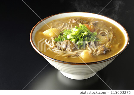 Hot curry soba noodles with plenty of green onions photographed against a black background Hot curry soba noodles with plenty of green onions photographed against a black background 115603275