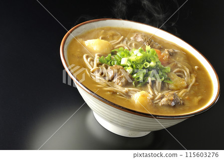 Hot curry soba noodles with plenty of green onions photographed against a black background Hot curry soba noodles with plenty of green onions photographed against a black background 115603276