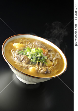 Hot curry soba noodles with plenty of green onions photographed against a black background Hot curry soba noodles with plenty of green onions photographed against a black background 115603288