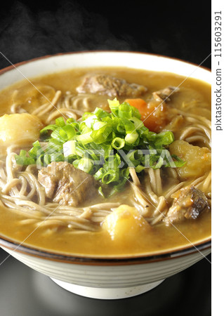 Hot curry soba noodles with plenty of green onions photographed against a black background 115603291