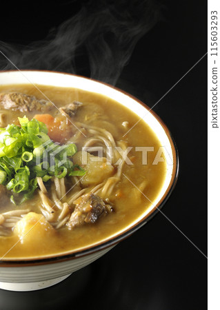 Hot curry soba noodles with plenty of green onions photographed against a black background Hot curry soba noodles with plenty of green onions photographed against a black background 115603293