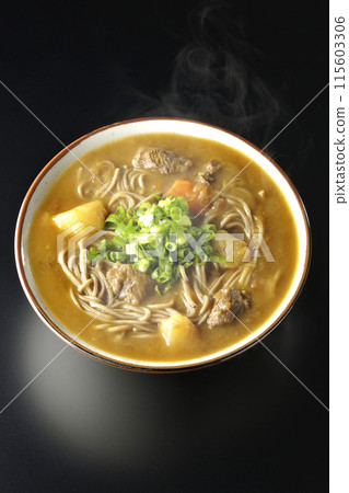 Aerial view of hot curry soba noodles with plenty of green onions against a black background Aerial view of hot curry soba noodles with plenty of green onions against a black background 115603306