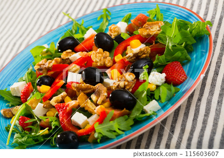 Salad of arugula with tomatoes, pepper, feta cheese, strawberry 115603607
