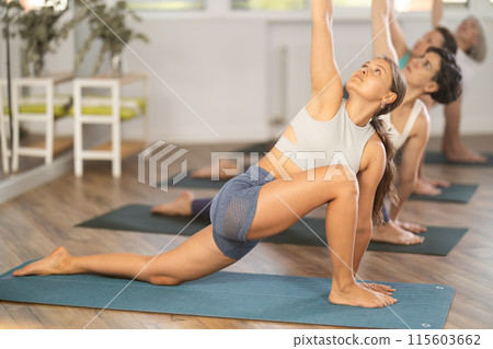 Young woman doing pilates in group in studio 115603662