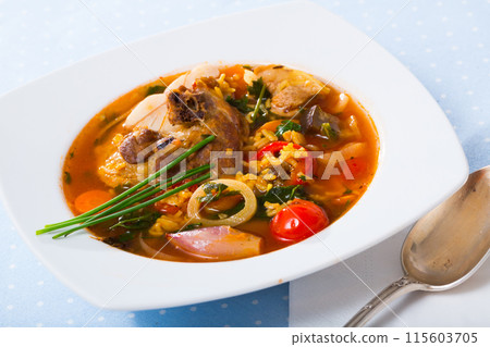 Lamb's soup cooked with rice, vegetables, onion and garlic 115603705