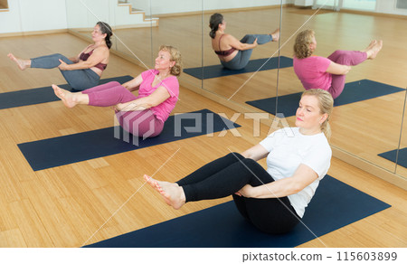 Active senior women practicing balancing yoga poses 115603899