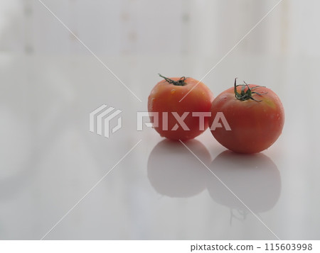 Cherry tomatoes with water droplets (two, white background) Cherry tomatoes with water droplets (two, white background) 115603998