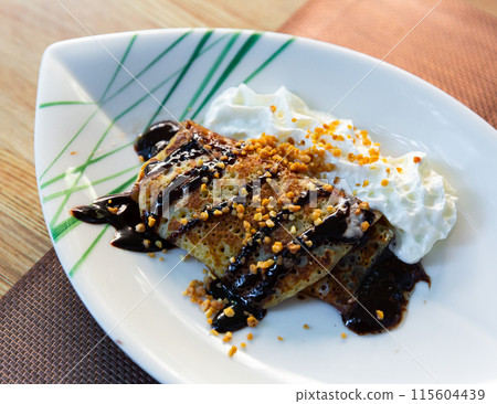 Crepes with cream cheese mousse, nut, chocolate 115604439