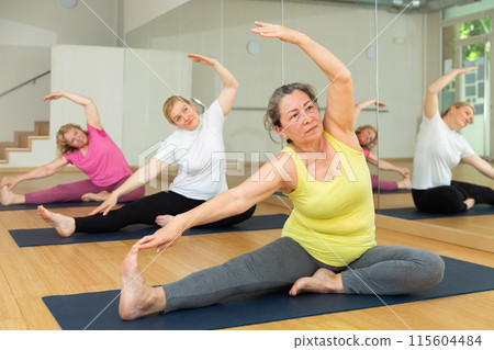 Group yoga modern class - pose matsiendrasana 115604484