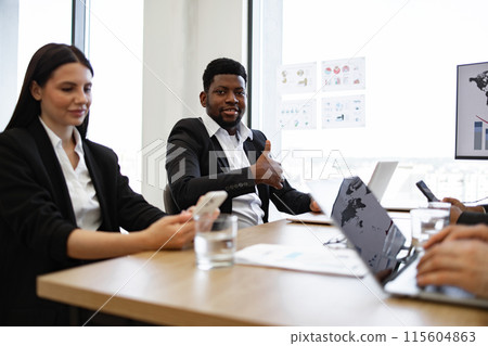Diverse business team having a meeting in a modern office Diverse business team having a meeting in a modern office 115604863