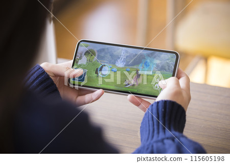 High school girl playing smartphone games in a school classroom 115605198