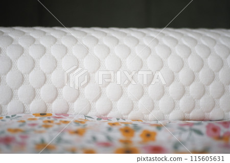 Orthopedic pillow on a bed  115605631
