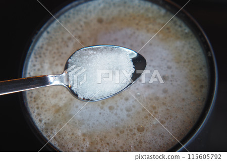 dropping sugar from a spoon in a coffee cup , dropping sugar from a spoon in a coffee cup , 115605792