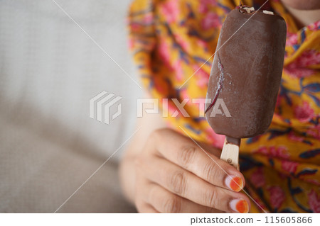 young women eating chocolate flavor ice cream  115605866