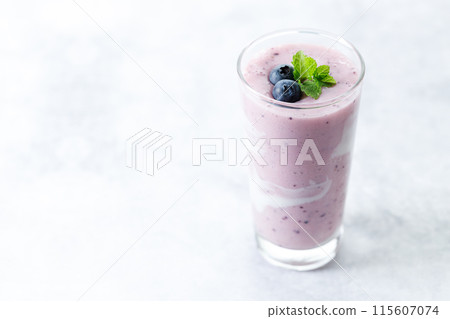 Blueberry smoothie with yogurt in a glass. 115607074