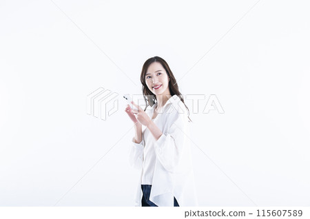 A young woman operating a smartphone A young woman operating a smartphone 115607589