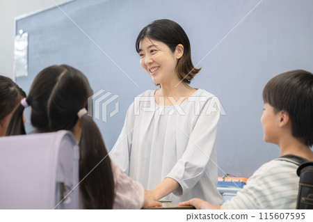 Image of a teacher speaking to students at a school podium 115607595
