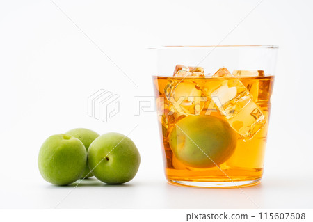 Amber-colored aged plum wine and plums 115607808