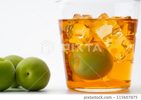 Amber-colored aged plum wine and plums 115607875