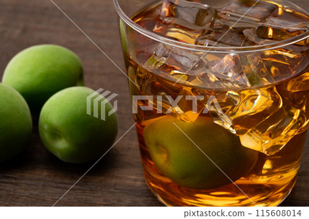 Amber-colored aged plum wine and plums Amber-colored aged plum wine and plums 115608014