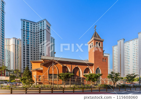 The beautiful Catholic church, designed with modern architecture and constructed from orange brick, reflects the stunning evening light. The beautiful Catholic church, designed with modern architecture and constructed from orange brick, reflects the stunning evening light. 115608060