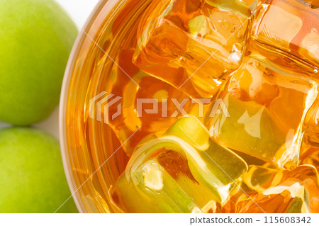 Close-up of plum wine on the rocks in a glass 115608342