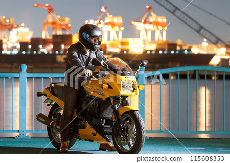 晚上，一名男子在港口騎摩托車 115608353